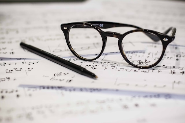 Music sheet with glasses and pen